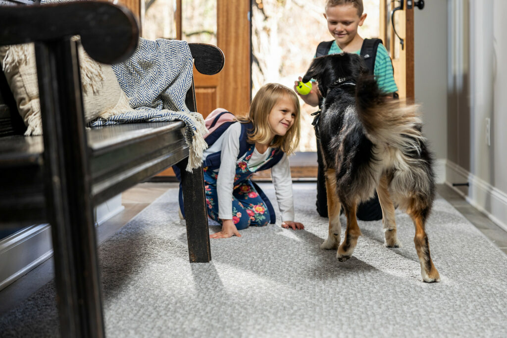 Kids playing with dog | Kirkland's Flooring
