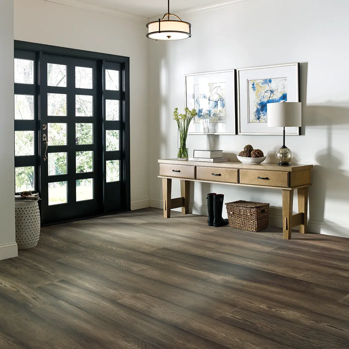 Dark brown hardwood in an entryway with a black front door | Kirkland's Flooring