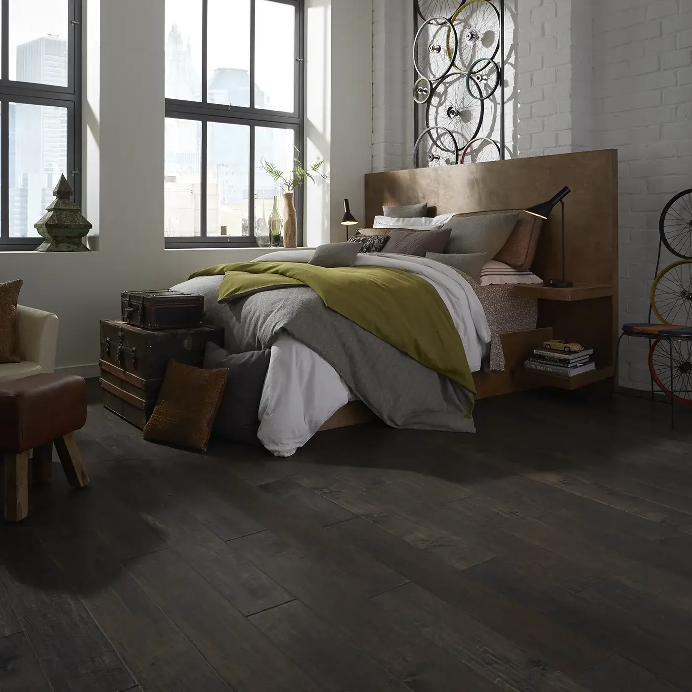 Dark hardwood in a modern bedroom with a large bed | Kirkland's Flooring
